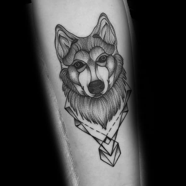 Geometric Siberian Husky tattoo on a man's forearm, featuring fine line work, shading, and angular shapes for a modern and artistic look.