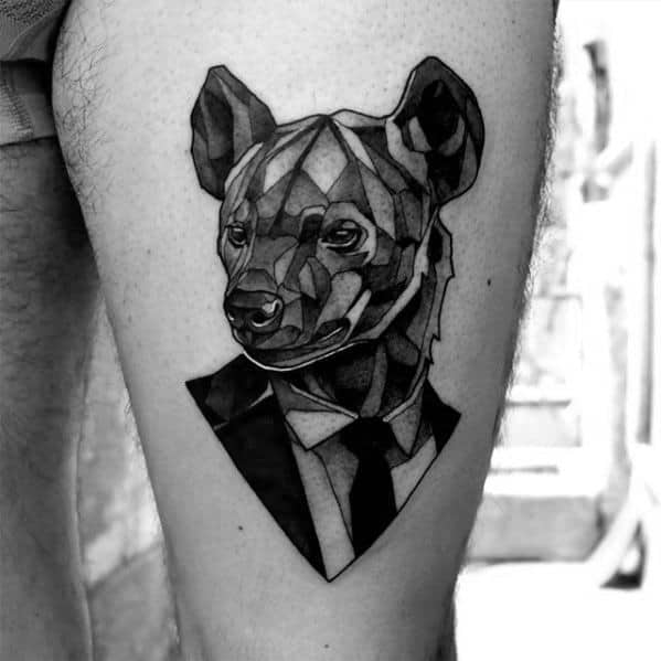 Geometric-style hyena tattoo on the thigh, featuring a faceted design with the hyena wearing a suit and tie, blending abstract and formal elements.