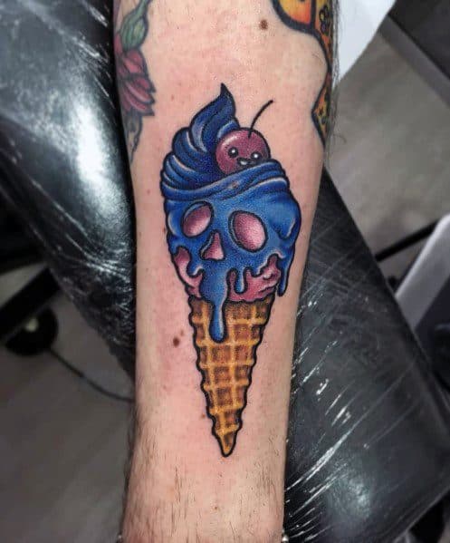 Tattoo of a spooky ice cream cone with a skull-shaped scoop, melting blue frosting, and a cherry on top, blending horror and vibrant colors.