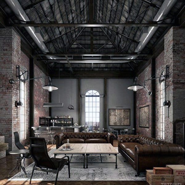 Industrial loft living room with exposed brick walls, leather sofas, and high vaulted ceiling.