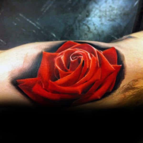 Tattoo of a realistic red rose with dark shading around it