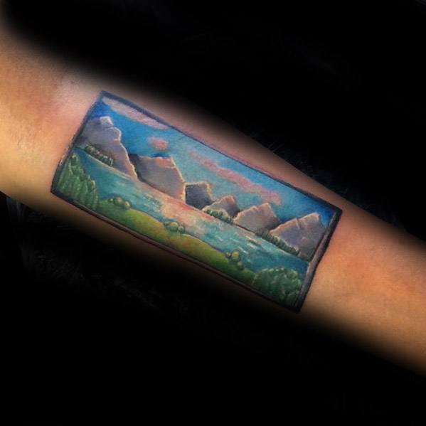 Vibrant rectangular tattoo of a lake and mountain range with soft clouds and greenery, designed like a scenic landscape painting.