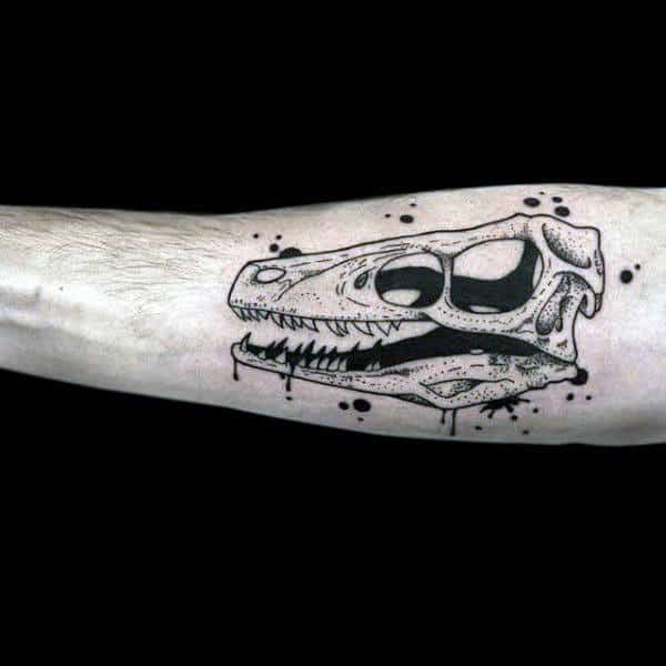 Mens Inner Forearm Tattoo Of Velociraptor Skull With Black Ink Paint Splatter Design