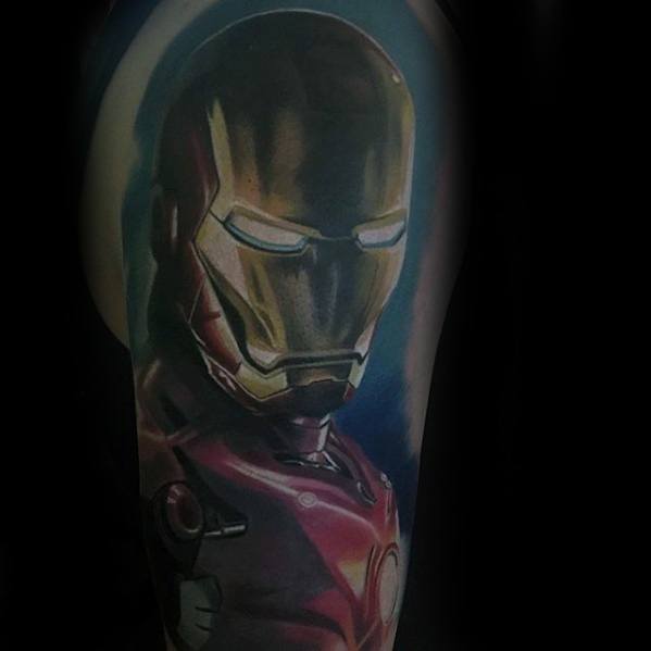 Iron Man tattoo featuring a detailed, realistic portrait of his helmet, with vibrant colors and dynamic shading that highlight the metallic finish and glowing blue eyes.