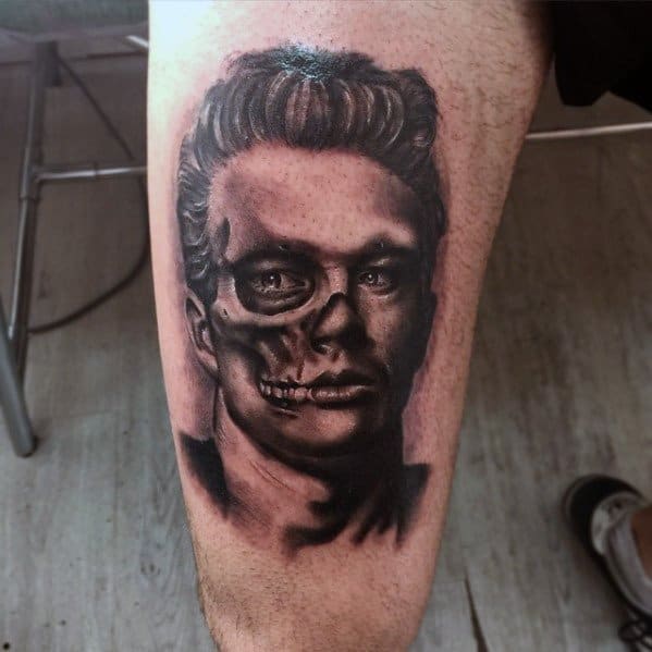 Dark realism tattoo of James Dean with half his face depicted as a skull, blending life and death in a striking split-face design.