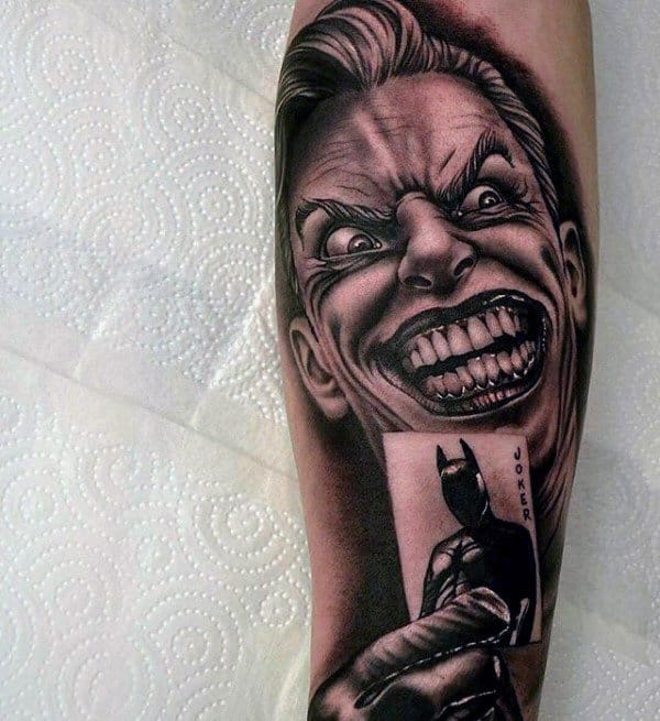 Mens Joker Holding Playing Card Of Batman Arm Tattoos