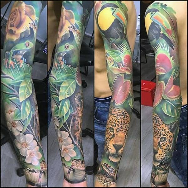 Colorful nature-themed sleeve tattoo with frogs, orchids, leaves, toucans, and a leopard on a person's arm