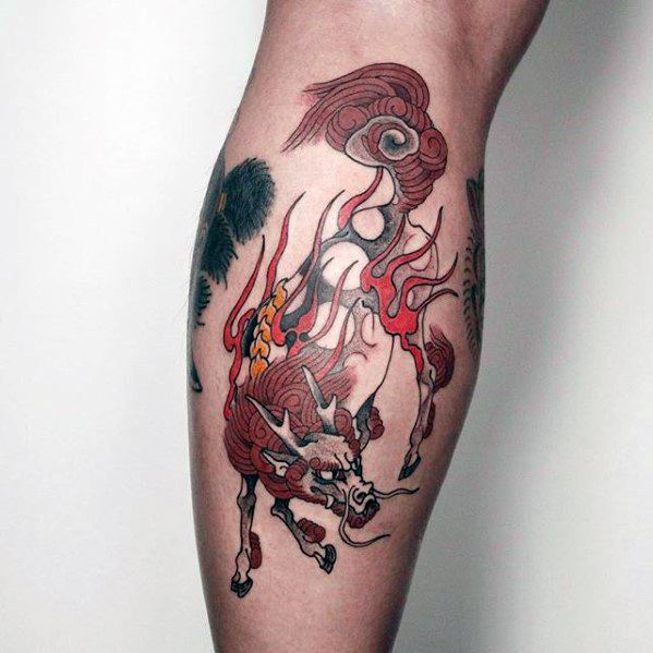 Red and white Kirin tattoo on the calf with flowing mane, leaping posture, and swirling flames in a clean, minimalist traditional style.