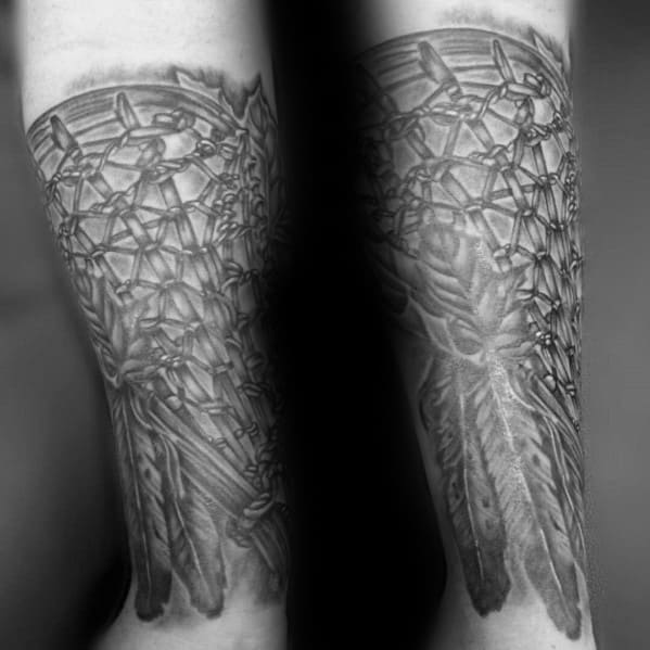 Highly detailed black and grey lacrosse stick tattoo with intricate netting and feather elements, covering the forearm for a bold and realistic look.