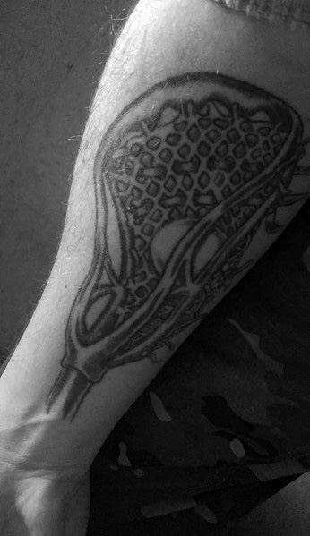 Bold black and grey lacrosse stick tattoo with detailed netting, placed on the forearm for a strong and athletic design.