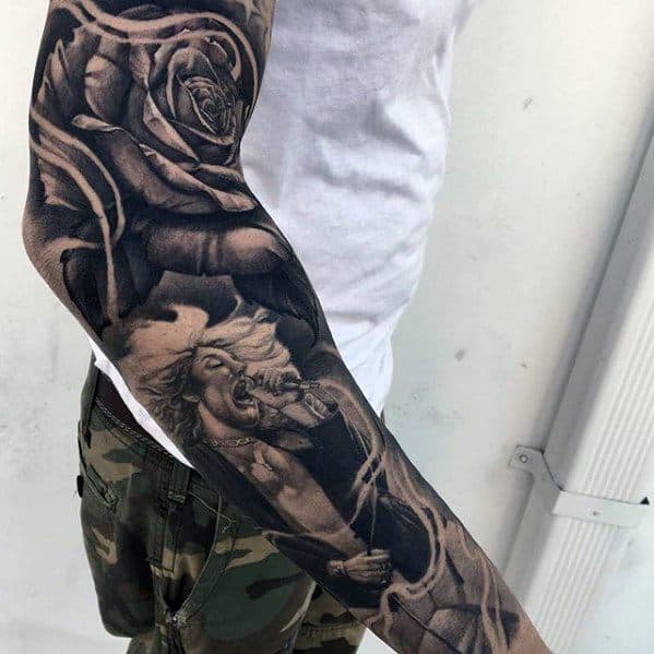 Black and gray full sleeve tattoo featuring Robert Plant singing with flowing hair, surrounded by large detailed roses.