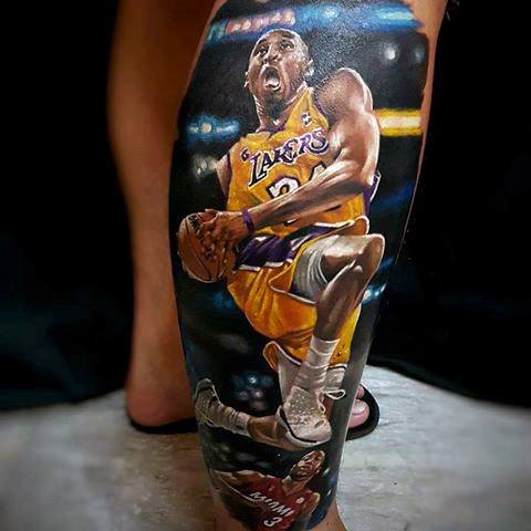 A detailed tattoo of Kobe Bryant in action, soaring towards the basket in his Lakers jersey with number 24, showcasing his intensity and athleticism.