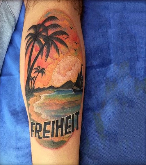 Mens Leg Tattoo Of Ship At Sunset With The Word Freiheit Traditional Style