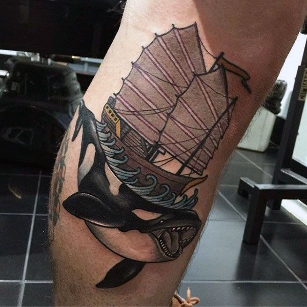 Vivid tattoo on the forearm featuring an orca whale with a ship above it, surrounded by waves, combining elements of nature and maritime symbolism.