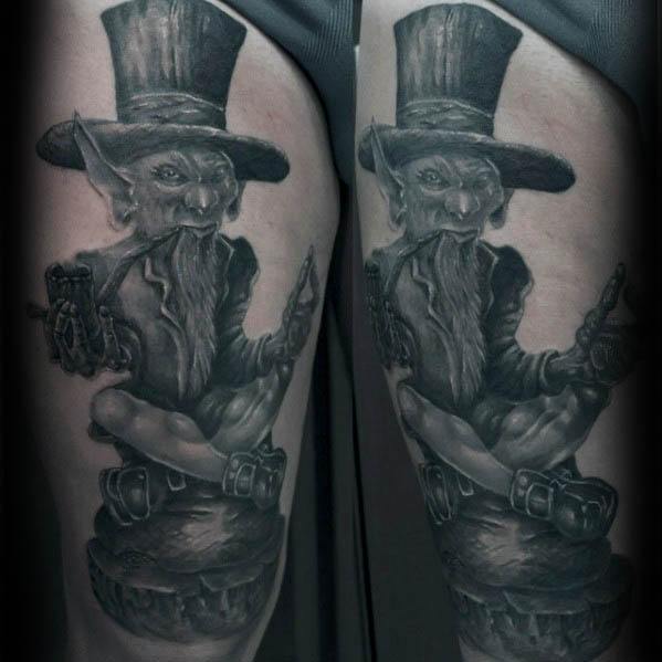 Dark and detailed black and grey tattoo of a sinister leprechaun with sharp features, smoking a pipe and holding guns while sitting cross-legged.