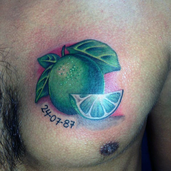 Realistic lime tattoo with vibrant green shading, detailed leaves, and a lime wedge, complemented by a meaningful date for a personal touch.