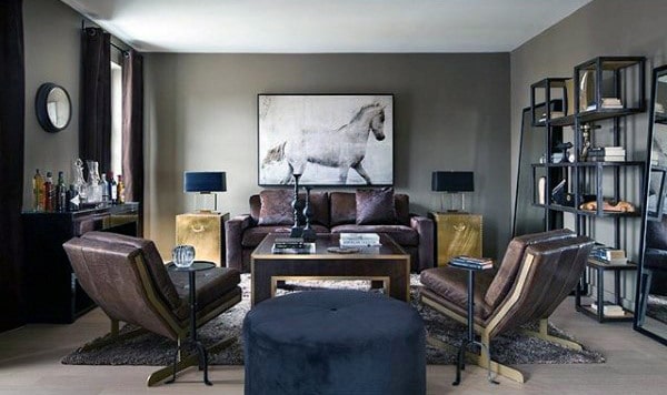 Modern living room with leather chairs, horse artwork, and sleek shelving units.