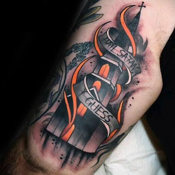 Stylized burning church tattoo with bold orange flames and glowing windows. A ribbon wraps around it reading “Hail Satan, I Guess...”.