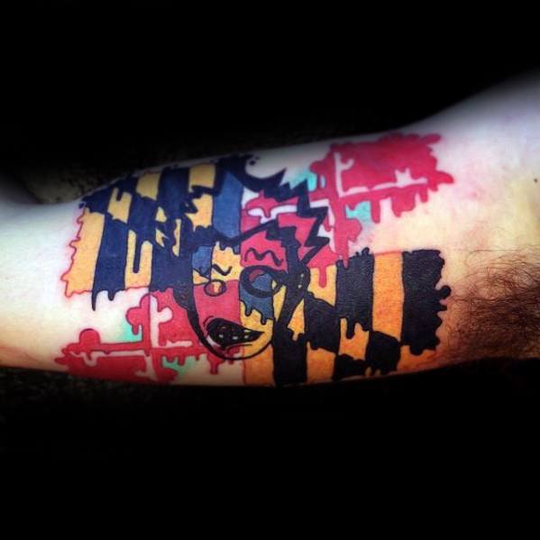 Maryland flag tattoo with a dripping paint and abstract design on the forearm, creating a bold and artistic take on state pride.