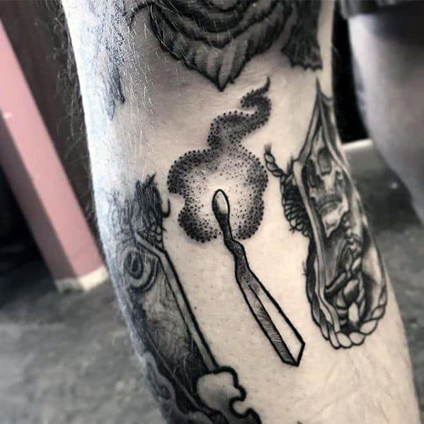 Dotwork tattoo of a matchstick with swirling smoke, combining minimalism and texture to represent fleeting energy or a burned-out state.