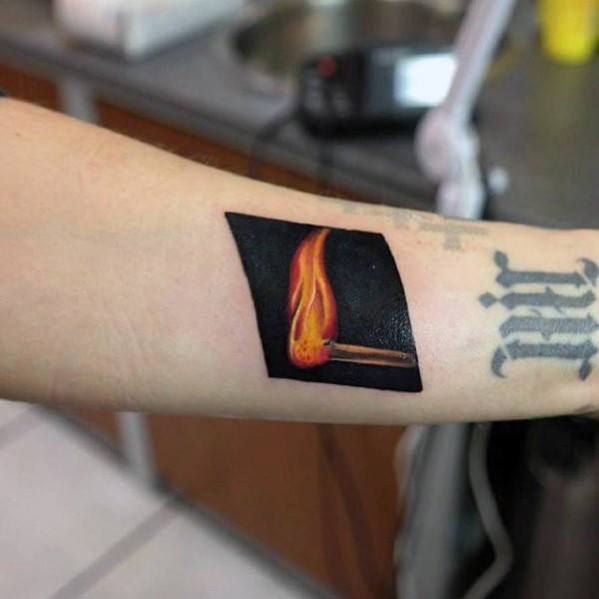 Realistic matchstick tattoo with a vivid flame against a solid black background, symbolizing ignition, bold energy, or sparking change.