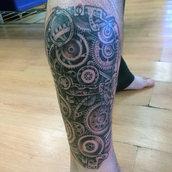 Tattoo of intricate clockwork gears covering a lower leg