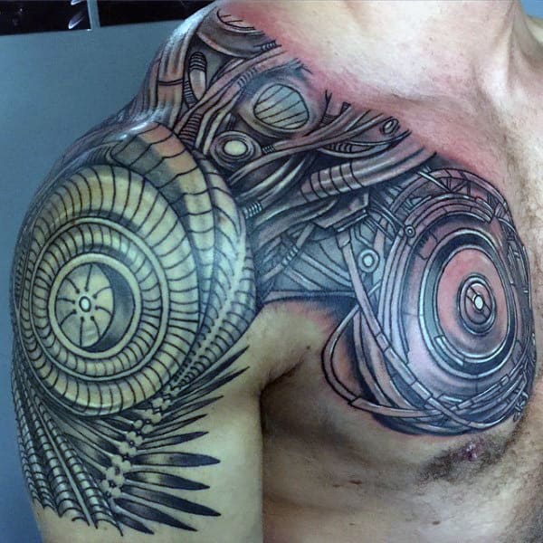 Intricate biomechanical tattoo covering a man's shoulder and upper chest