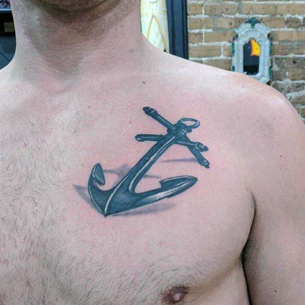 A simple anchor tattoo near the left shoulder