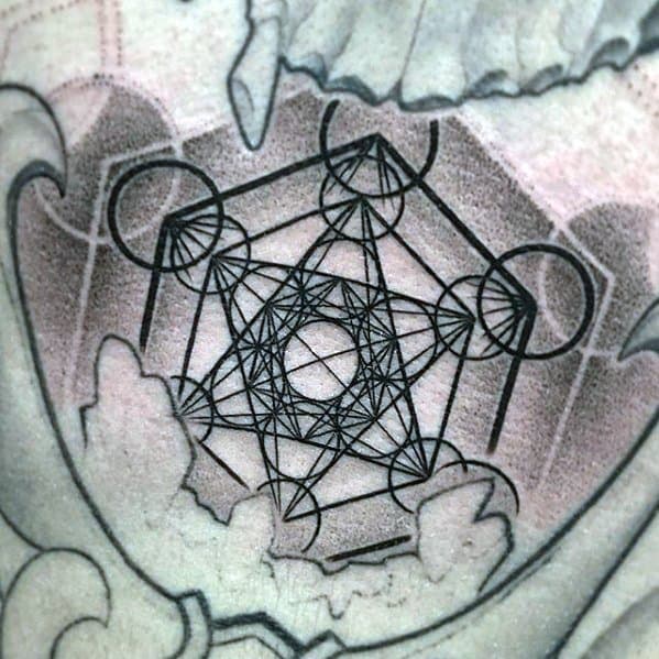 Metatron’s Cube tattoo with sharp black lines nestled within a shaded ornamental frame, blending sacred geometry with abstract elements.