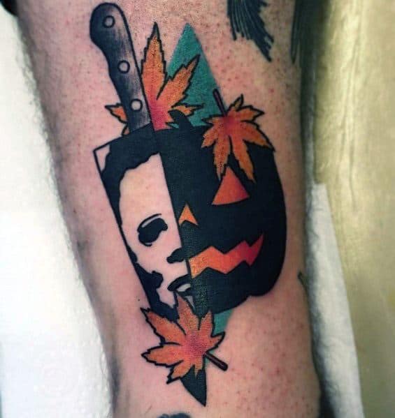Creative Michael Myers tattoo with a split design, featuring his masked face, a jack-o'-lantern, autumn leaves, and a knife for a Halloween vibe.