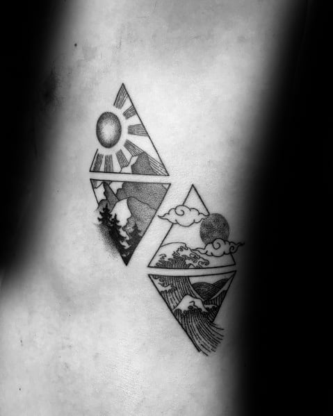 Black ink geometric tattoo featuring two diamond shapes, one with mountains and a sun, the other with waves and clouds, symbolizing nature’s harmony.