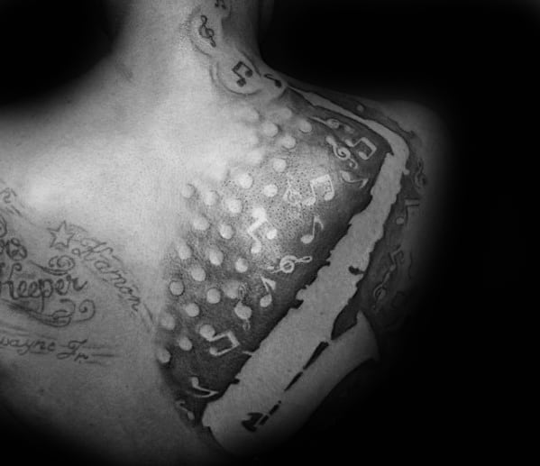 Mens Music Notes With Saxophone Negative Space Upper Back Tattoos