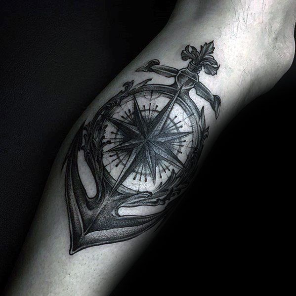 Anchor and compass tattoo design on forearm in black and grey ink
