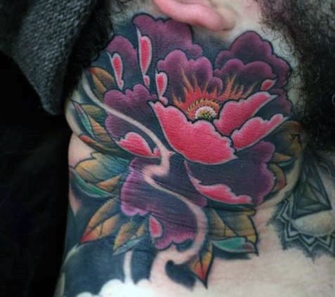 Vibrant pink flower tattoo on a person's neck with green leaves and dark shading