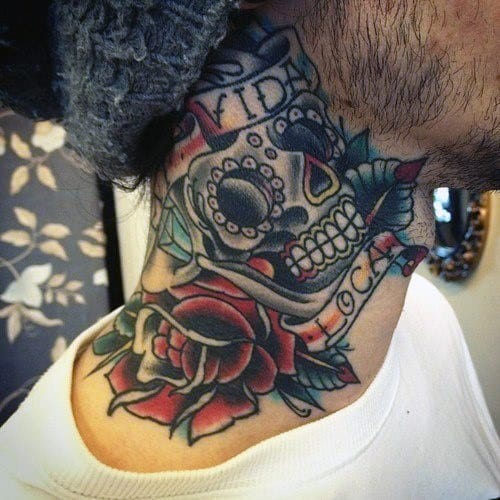 Tattoo of a sugar skull and rose on the side of a person's neck