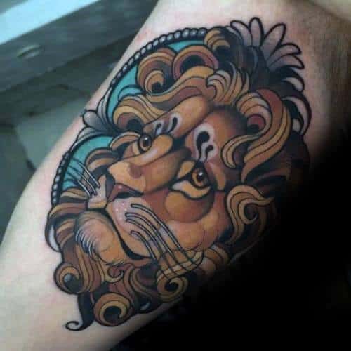 Neo-traditional lion tattoo with a soft, expressive gaze and flowing mane framed by teal and ornate decorative elements.