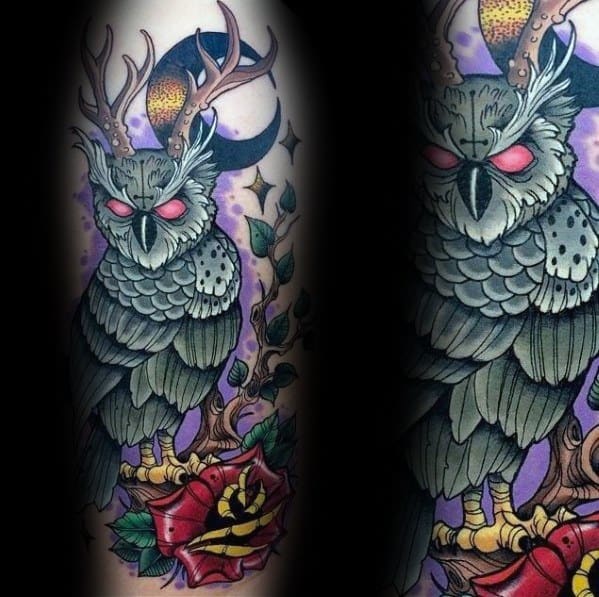 Neo-traditional owl tattoo with glowing red eyes, antlers, a crescent moon, and a rose, creating a mystical and gothic-inspired design.