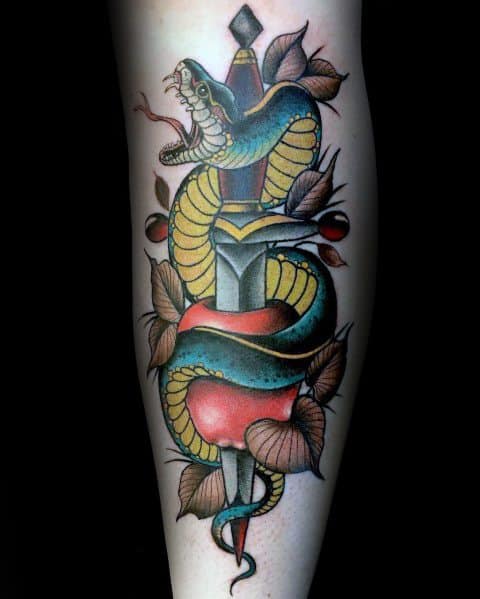 Neo-traditional tattoo of a blue and yellow snake coiled around a dagger, surrounded by leaves, with bold shading and striking red accents.