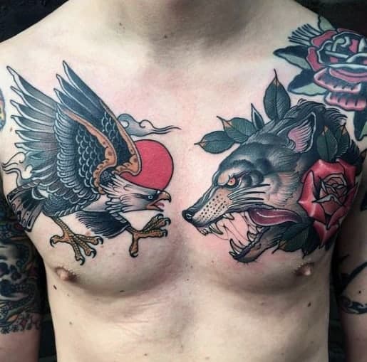 Chest tattoos of an eagle with a red sun and a wolf with roses on a person's upper body