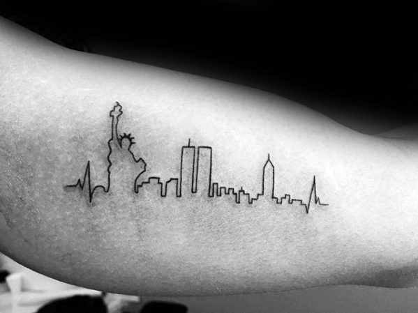 Clean black line tattoo of the New York City skyline with the Statue of Liberty and Twin Towers, bordered by heartbeat lines.