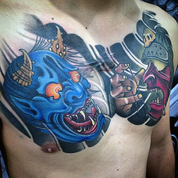 Dynamic chest tattoo featuring a vivid blue and red Hannya mask, blending dramatic expressions with intricate detail work