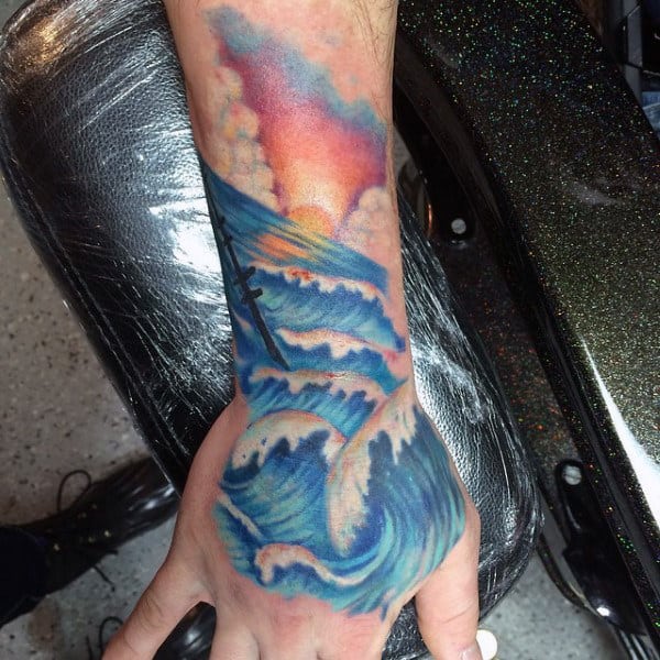 Mens Ocean Waves And Sunset Hand Tattoo In Traditional Style