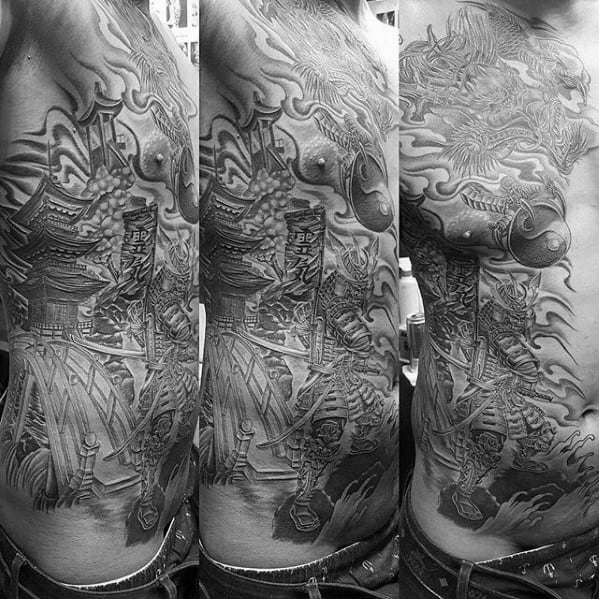 Intricate full torso tattoo in black and grey featuring a Japanese pagoda, samurai warrior, koi fish, bridge, and swirling smoke elements.