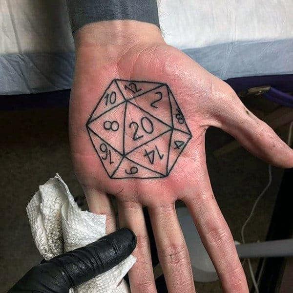 A hand tattoo of a 20-sided die from a tabletop game on a person's palm