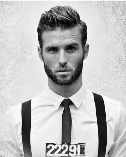 Voluminous quiff with a defined side part and a clean fade