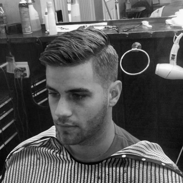 Classic side part with a clean fade and neatly combed top