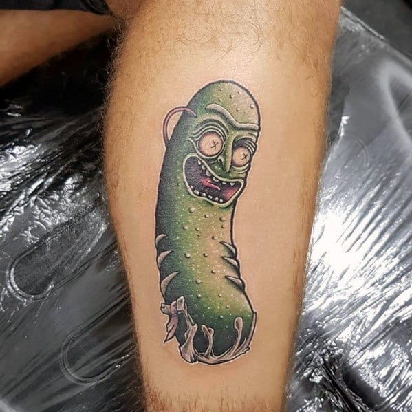 Dark and detailed Pickle Rick tattoo with a sinister expression, intense shading, and a horror-inspired design on the leg.