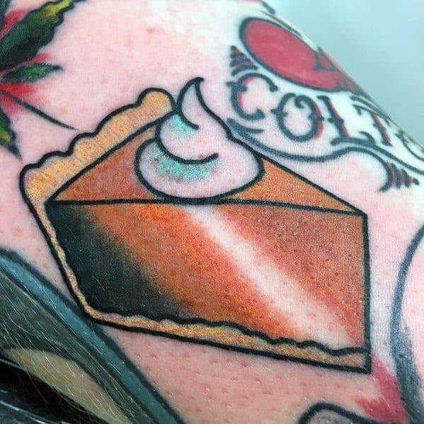 Bold traditional-style pumpkin pie tattoo with a golden crust, smooth filling, and a swirl of whipped cream, evoking cozy autumn vibes