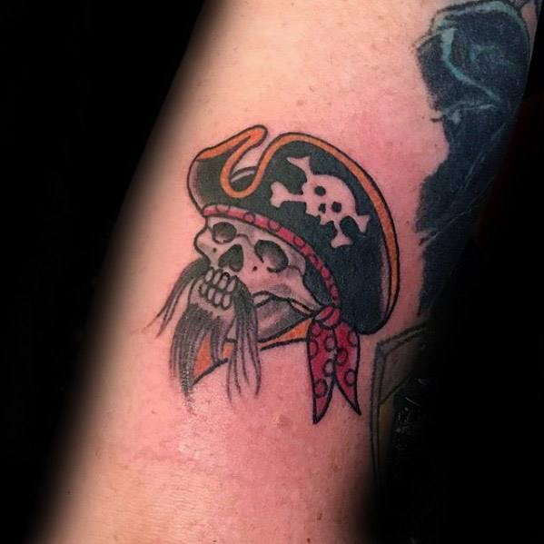 Skeleton pirate tattoo inspired by the Pittsburgh Pirates, featuring a skull with a red bandana and a black hat with skull emblem.