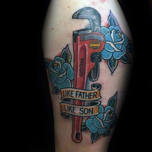 Tattoo of a red RIDGID pipe wrench surrounded by blue roses and a banner that reads LIKE FATHER LIKE SON in bold lettering.